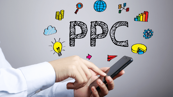 business person holding a phone with PPC written above