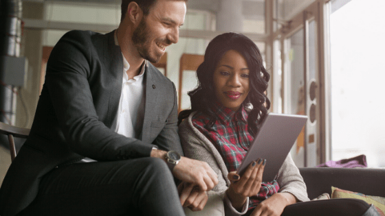 Man and woman looking at an ipad together in an office